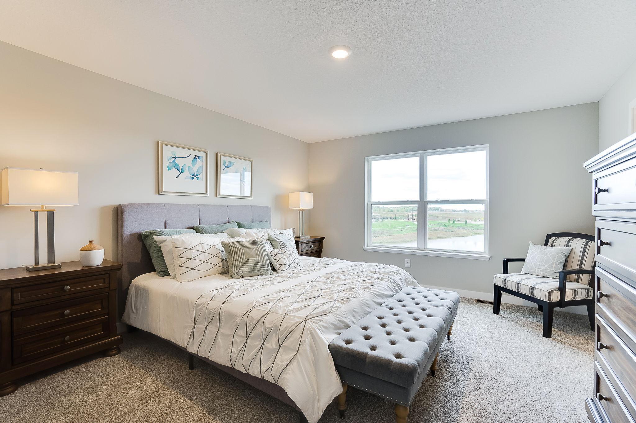 The primary suite has room for all your furniture and overlooks the backyard. (Model home, colors will vary)