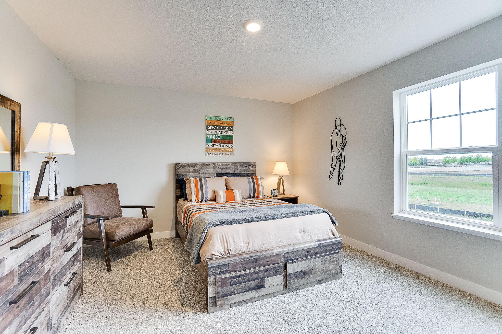 One of three additional bedrooms - all big enough to accommodate whatever setup you would like! (Model home, colors will vary)