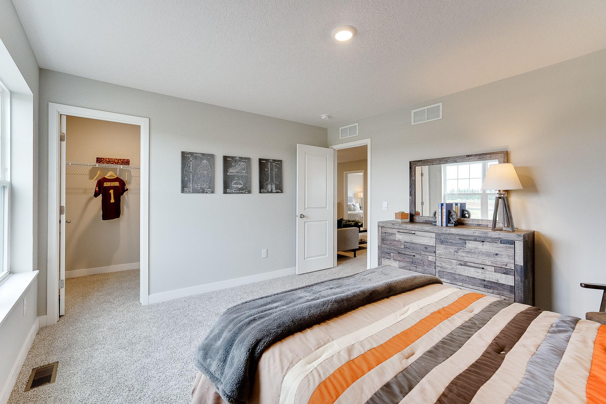 Another one of the secondary bedrooms with walk-in closet! (Model home, colors will vary)