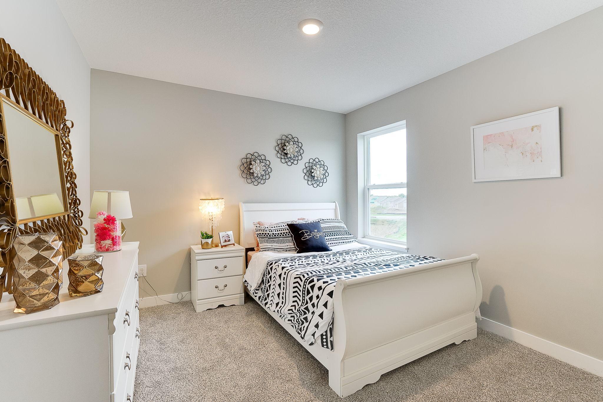 One of three additional bedrooms - all providing a great setting for the kids, guests, or an office. (Model home, colors will vary)