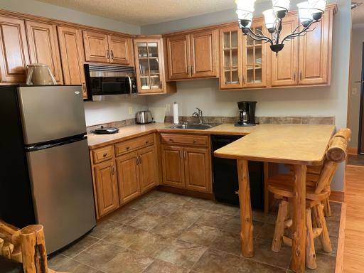 Fully furnished kitchen with SS frig, convection microwave, electric hot plate, dishwasher, toaster, coffee brewer, dishes and utensils.