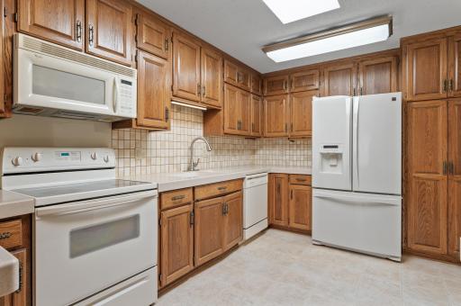Fantastic kitchen providing an abundance of storage, tile backsplash and skylight.