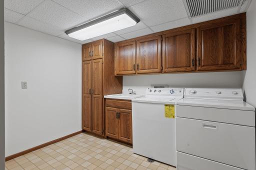 Convenient in-unit laundry room has tons of extra storage & utility sink.