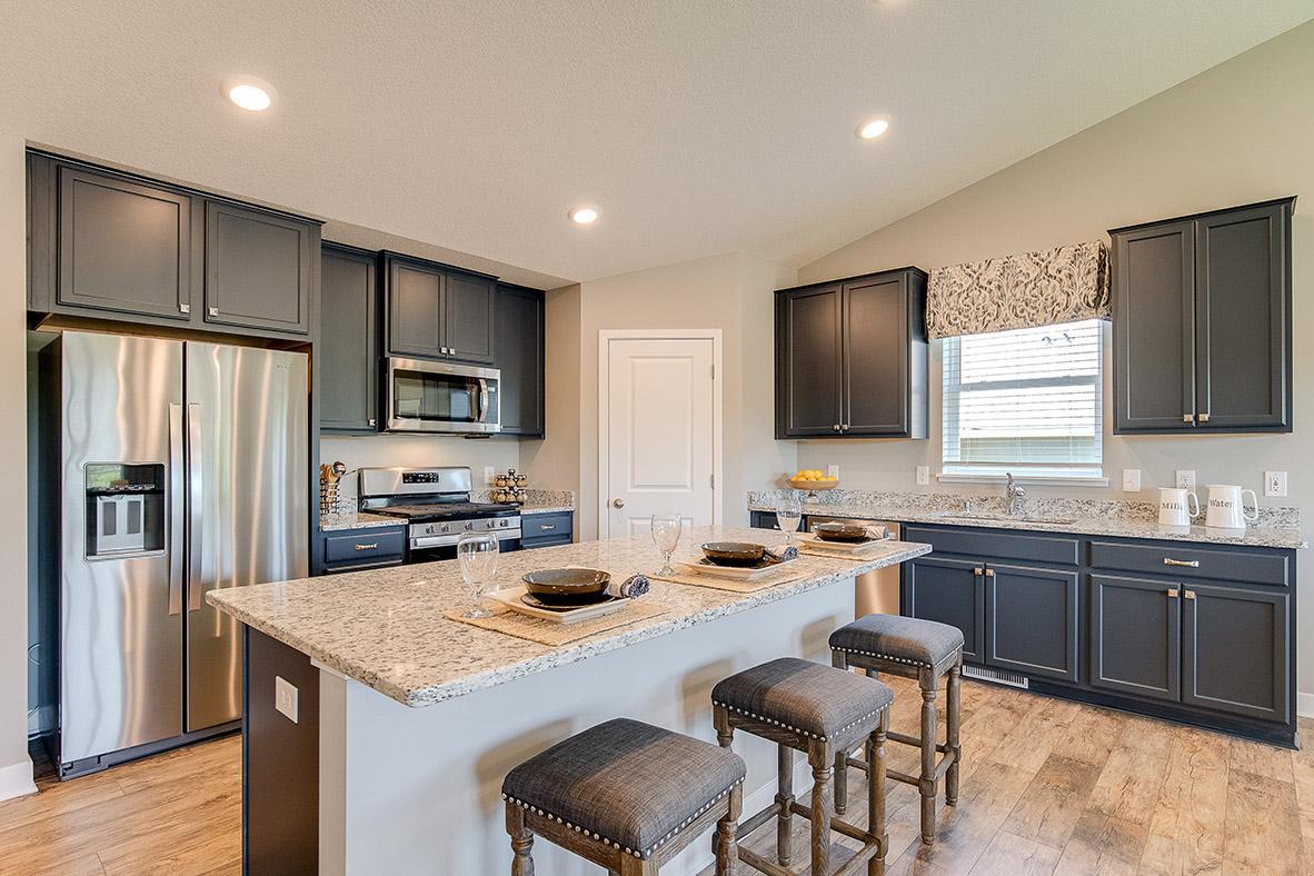 Welcome to the Finnegan! The heartbeat of the kitchen - this Island has loaded of counter space all coated in granite counter-tops with an overhang large enough to fit a handful of bar stools! Photo of model, colors will vary