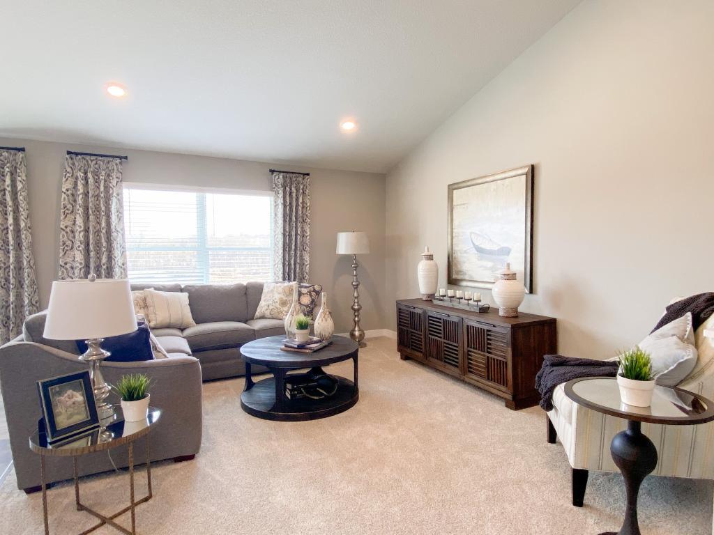 The home's main level living space is loaded with space and can accommodate just about any family room furniture set-up. Photo of model, colors will vary