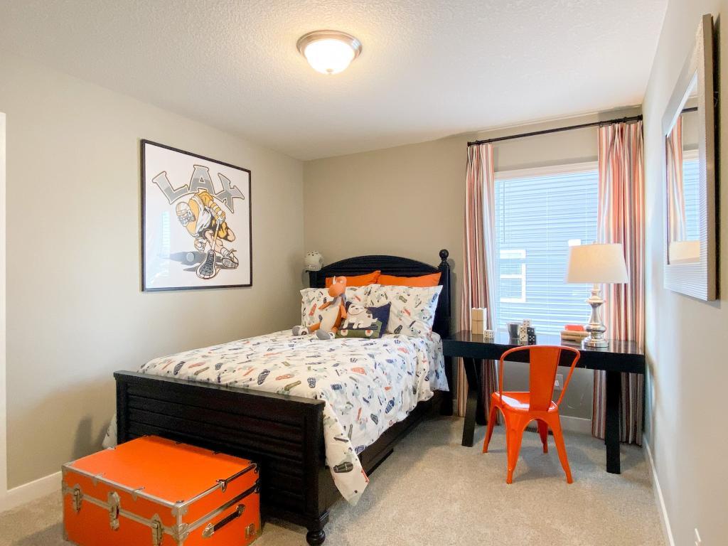 In addition to the primary bedroom, the home's upper level also includes these two additional bedrooms, and another full bathroom just adjacent to each! Photo of model, colors will vary