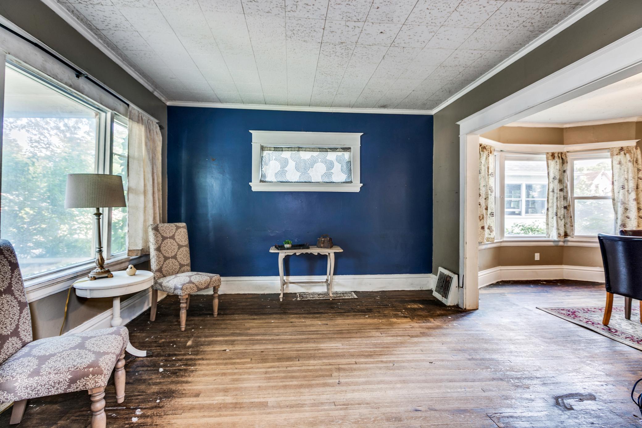 Living room and dining room have hardwood floors that could be gorgeous refinished.