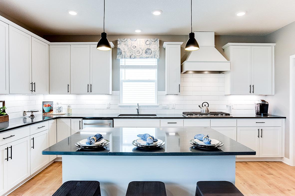 The anchor of the kitchen, the island will be coated with these same Quartz countertops and can serve as a perfect gathering piece for both family night, and while entertaining your guests! Photo of model home, color and options will vary.