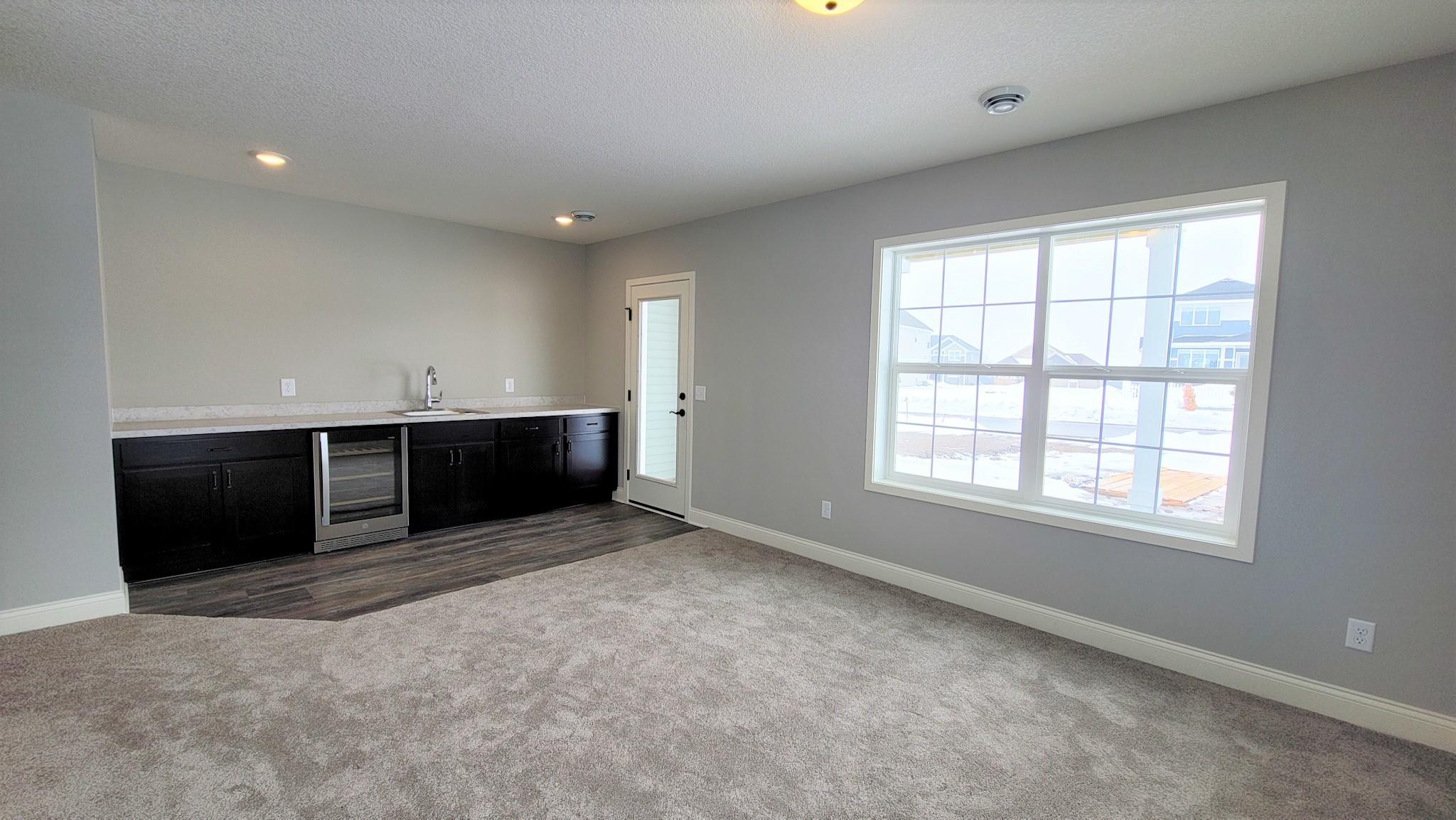 lower level family room with wet bar and door out to rear patio