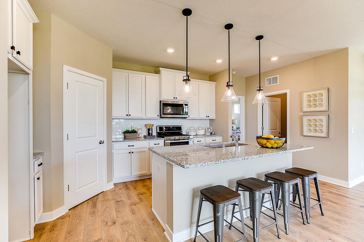 All of that beauty, yet still plenty of function! There's room to roam, a large walk-in pantry, awesome tiled-backsplash and vented micro-hood over the gas range! *Photo of previous model. Actual home may vary.