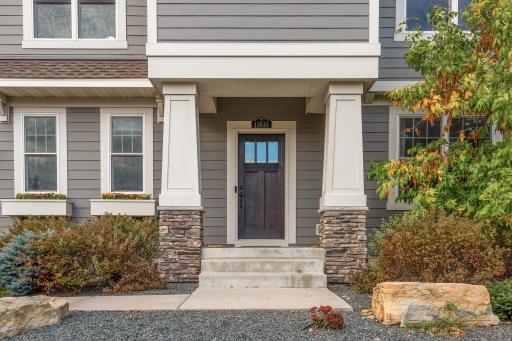 A covered front portico welcomes guests into this lovely home.