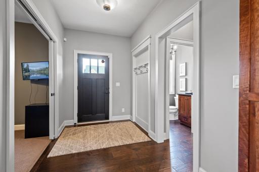 Just inside the front door, the foyer features a nook for guests to hang coats or purses or umbrellas.