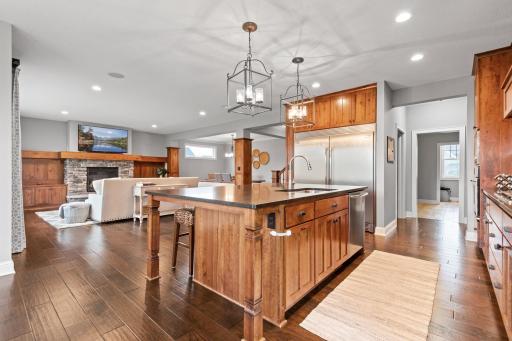 The kitchen shines with stainless steel appliances, soapstone countertops and a vast island with seating.