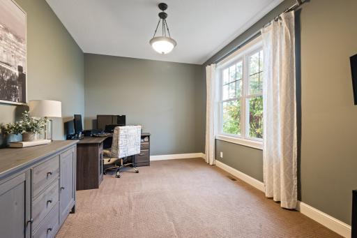 The large home office offers plenty of workspace and a pocket door for privacy when making calls or attending virtual meetings.