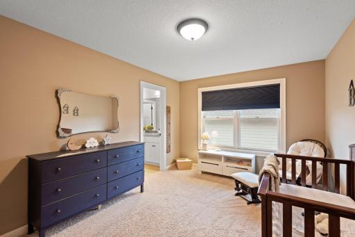 The generous second bedroom features a Jack-and-Jill bathroom, soft color palettes and cozy carpeting.