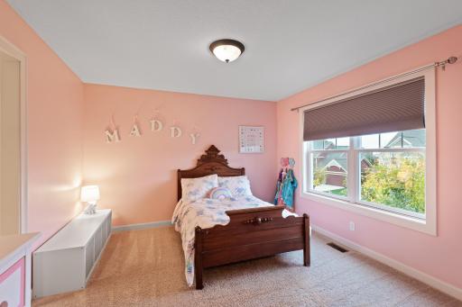 This princess suite features a large window with tree-top views, a walk-in closet and en-suite bath.