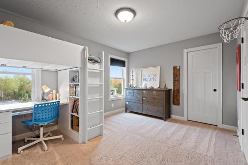 Offering plentiful space, natural light and neutral color pallet, this bedroom is also connected to the Jack-and-Jill bathroom.