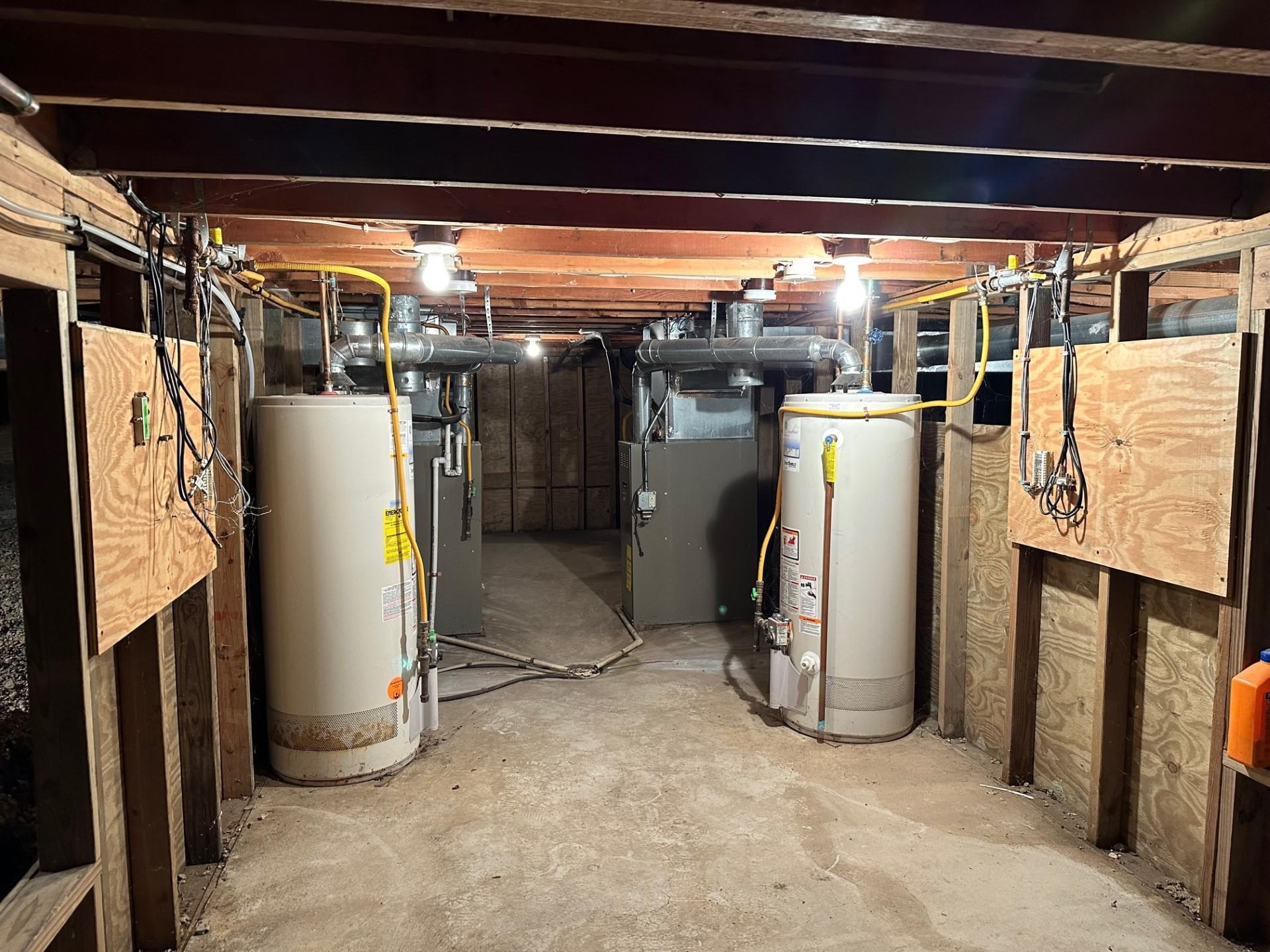 Basement headroom is about 5 1/2'. Furnaces and water heaters down in this space which can double as a storm shelter.
