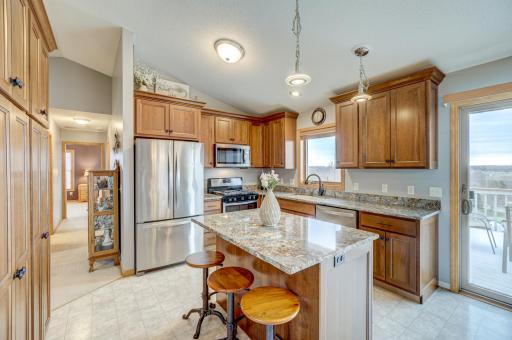 Beautiful cherry kitchen cabinets, soft-close drawers and doors, a large pantry, quartz countertops, and a center island