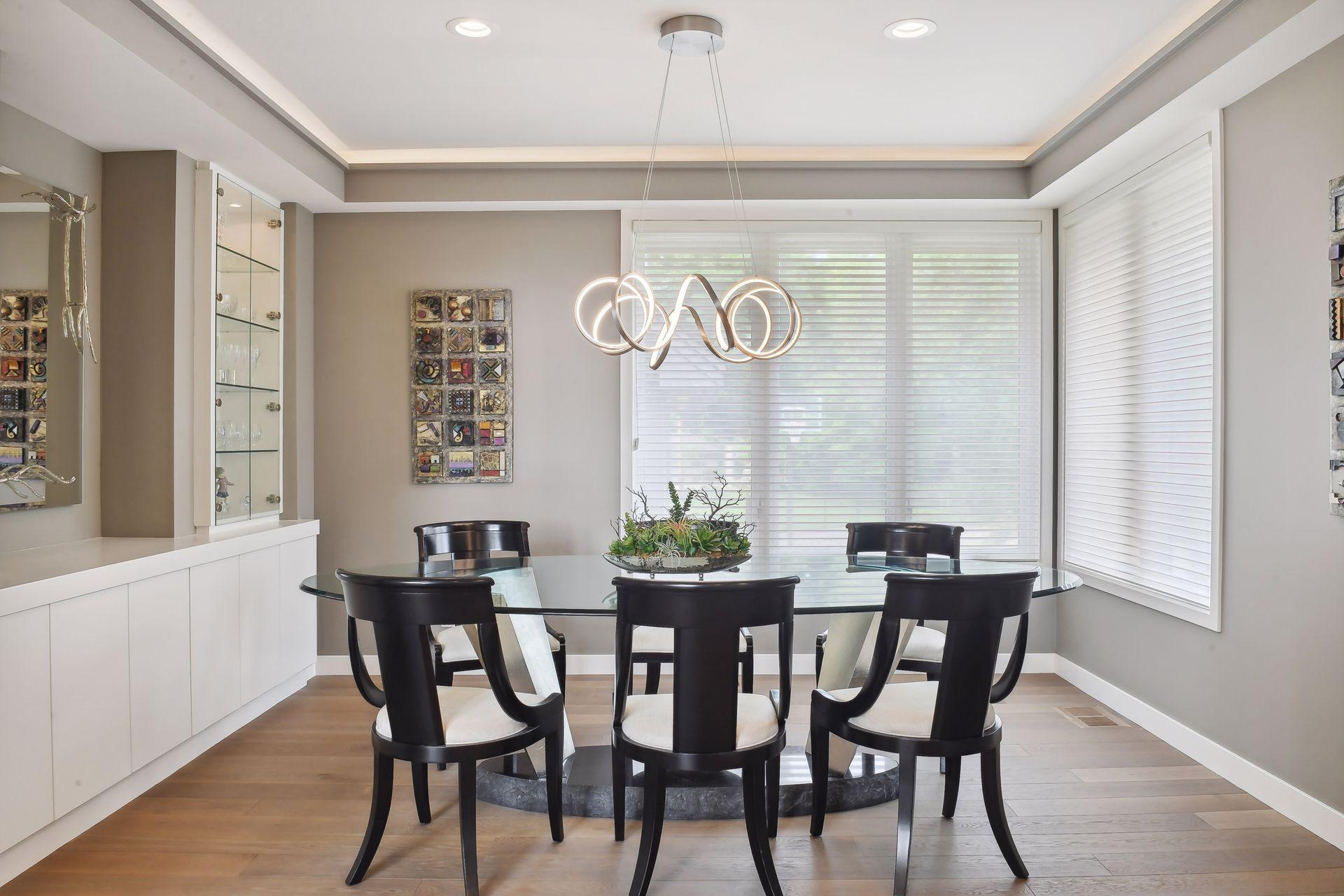 Elegant dining room offering custom built-ins & trayed ceiling.