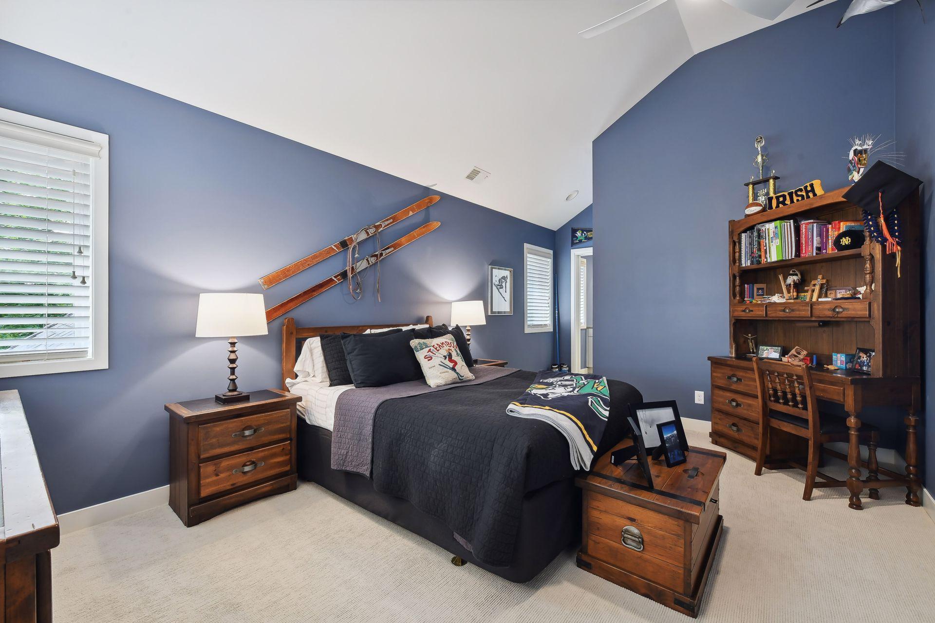 Upper level bedroom #1 with vaulted ceiling and attached bathroom and walk-in closet