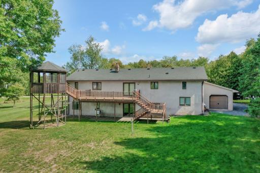 Large deck and gazebo, as well as a 4th garage door out the back of the 3rd stall of the attached garage.