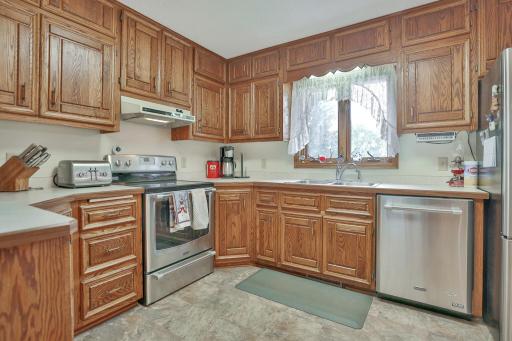 Solid oak raised panel oak cabinets with stainless appliances.