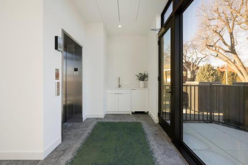 Interior penthouse landing with wet bar offers access to private rooftop decks.