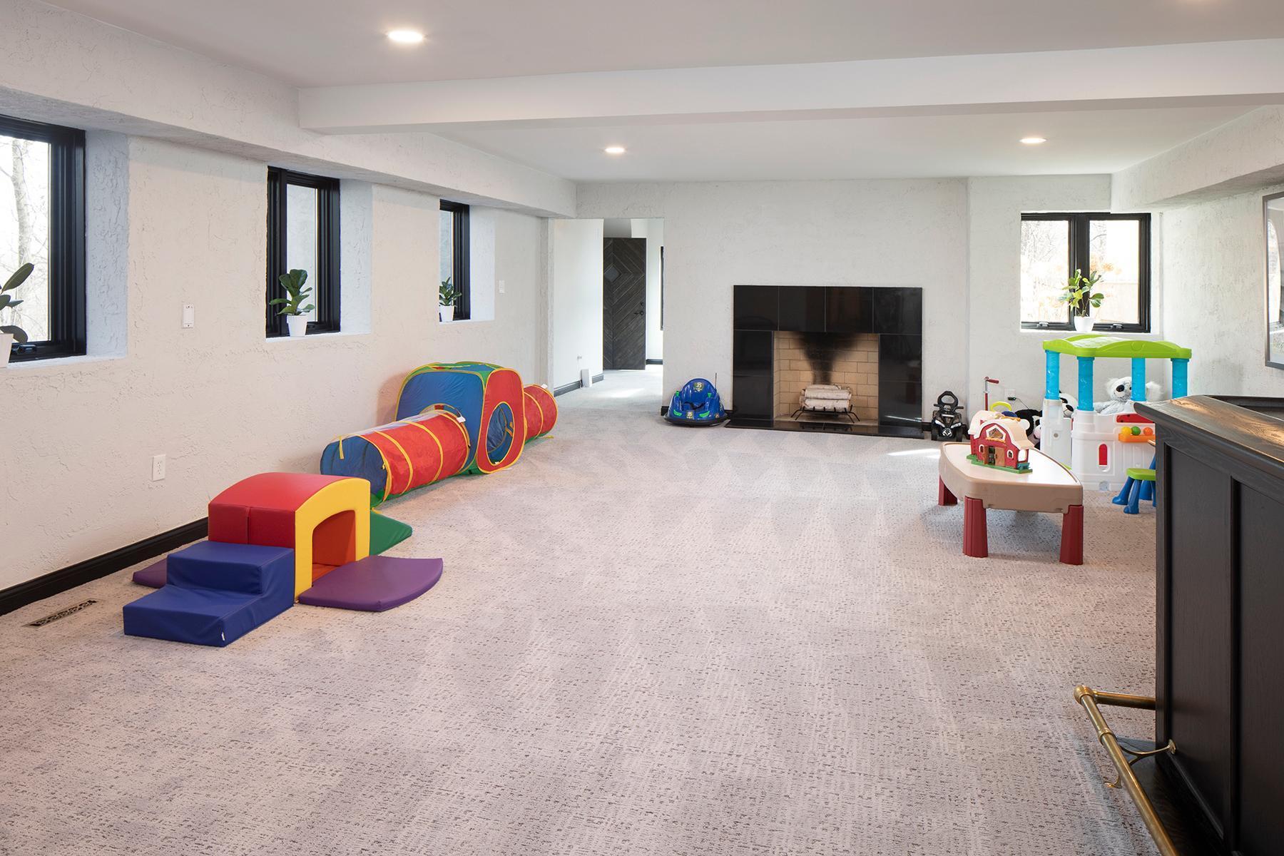 Lower level amusement room with woodburning fireplace and wetbar.