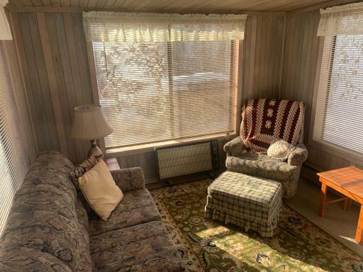 Detached sun porch with electric heat.