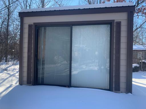 Detached sun porch with electric heat.