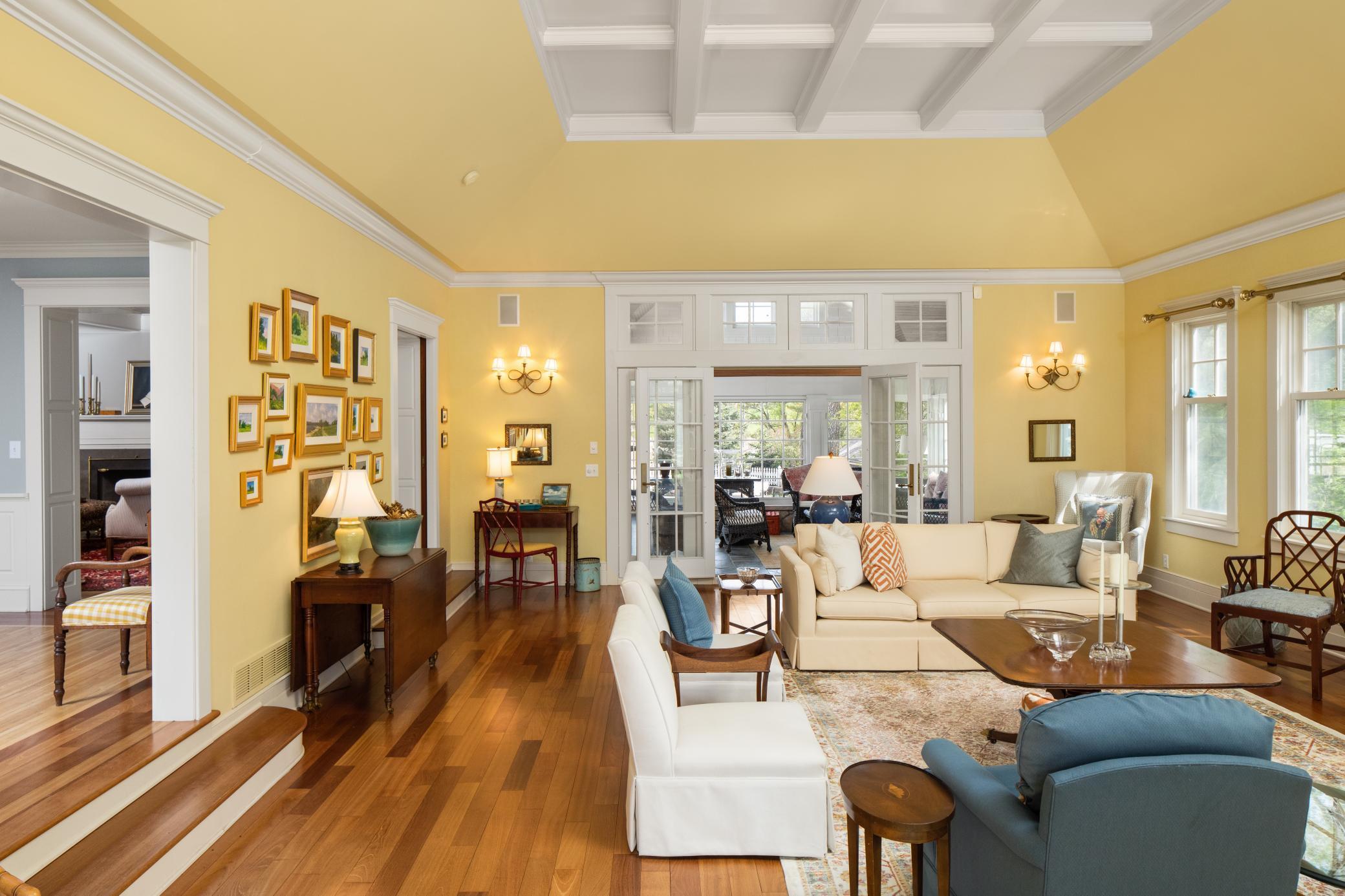 Formal living room with gorgeous hardwood floors, handmade moldings, and sun flowing throughout this entire space.