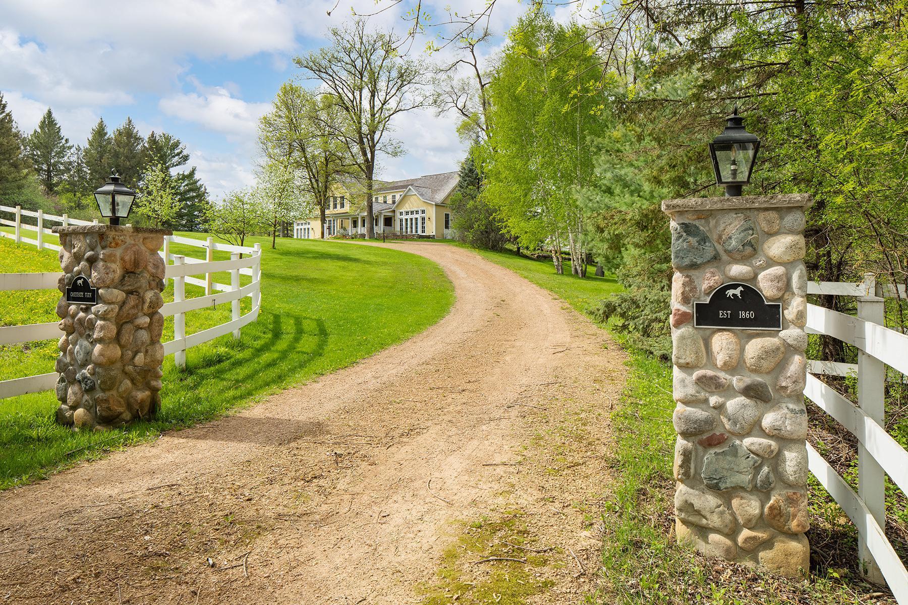 The Creekside Drive access onto the property is flanked by field stone pillars, Kentucky Rail fenced (entire grounds) and brings you to a circular drive. Second access to property brings you to barn and garages.