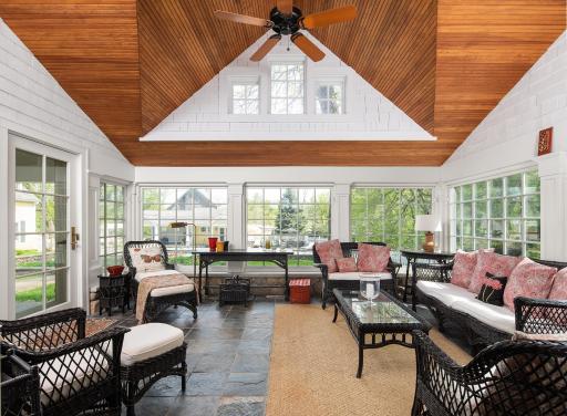 Beautiful four-season porch with vaulted beadboard ceiling, heated floors, and captivating views of the courtyard with pool and spa.