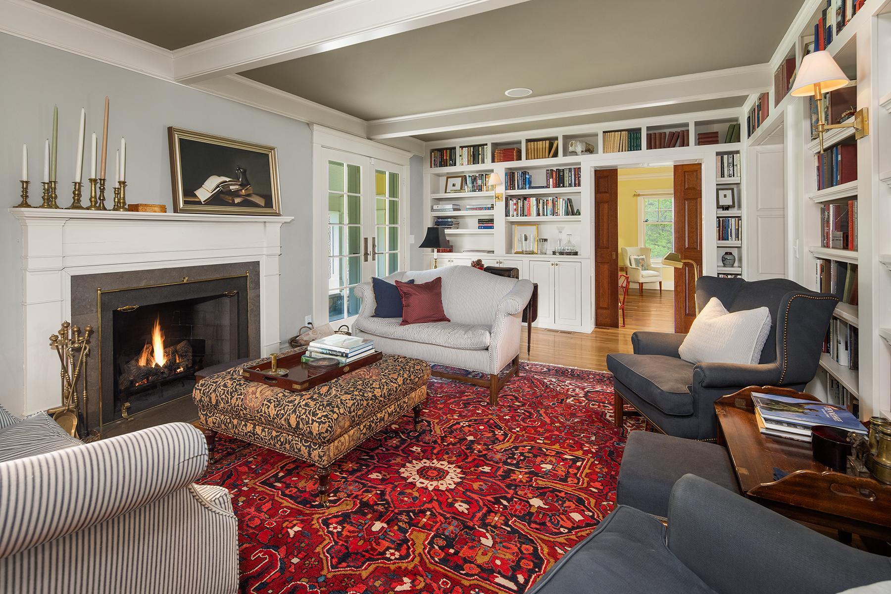 Step into one of the original main rooms of the historic farm that has been transformed into a library. Cozy up to the wood burning fireplace and take in the unique details; beamed ceiling, built ins, & soapstone surround fireplace with wood mantle.