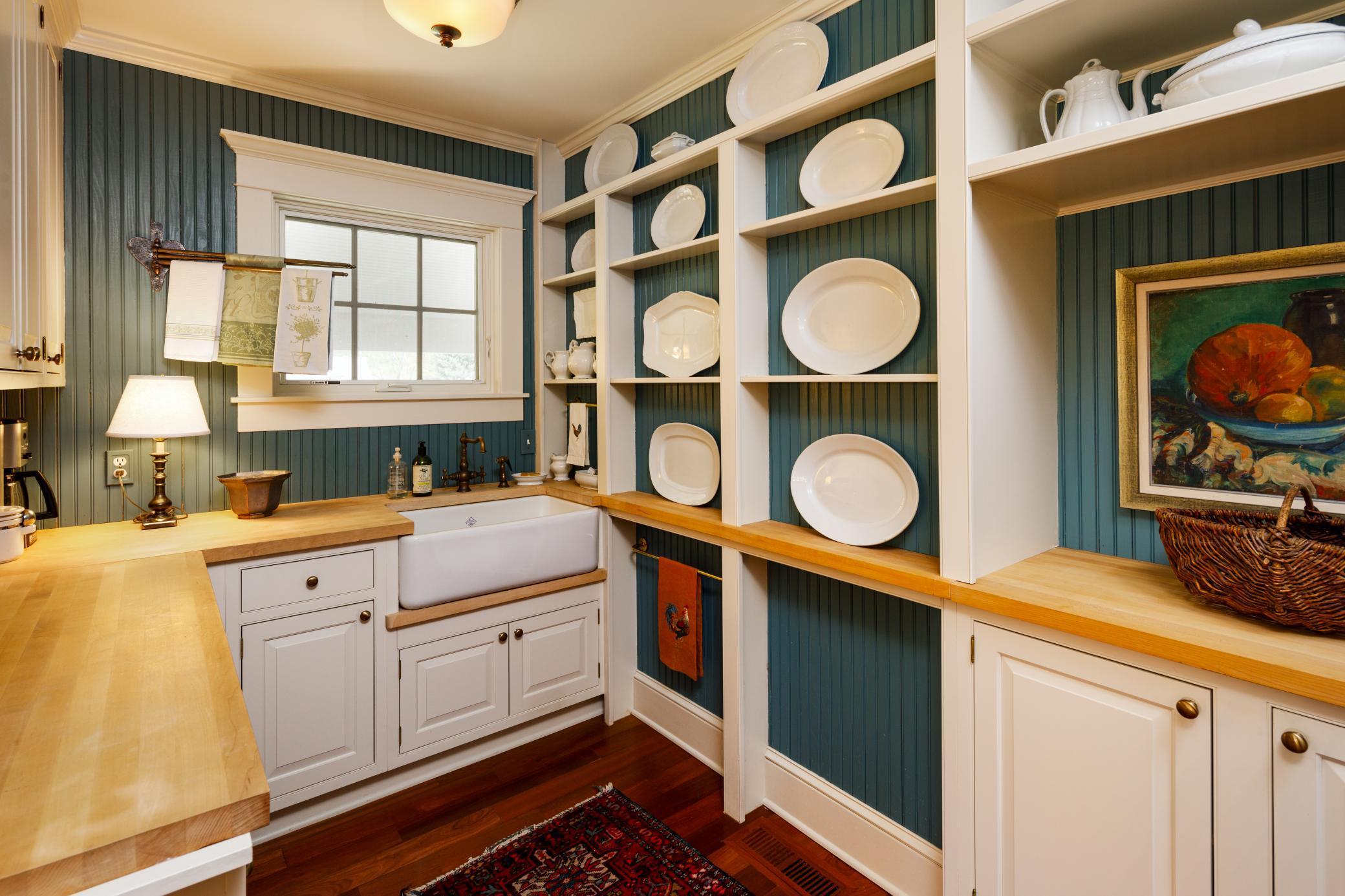 Butler's pantry offers additional prep space on the butcherblock counters. This space also includes a farmer's sink, dishwasher, warming drawer, refrigerator and freezer drawers.