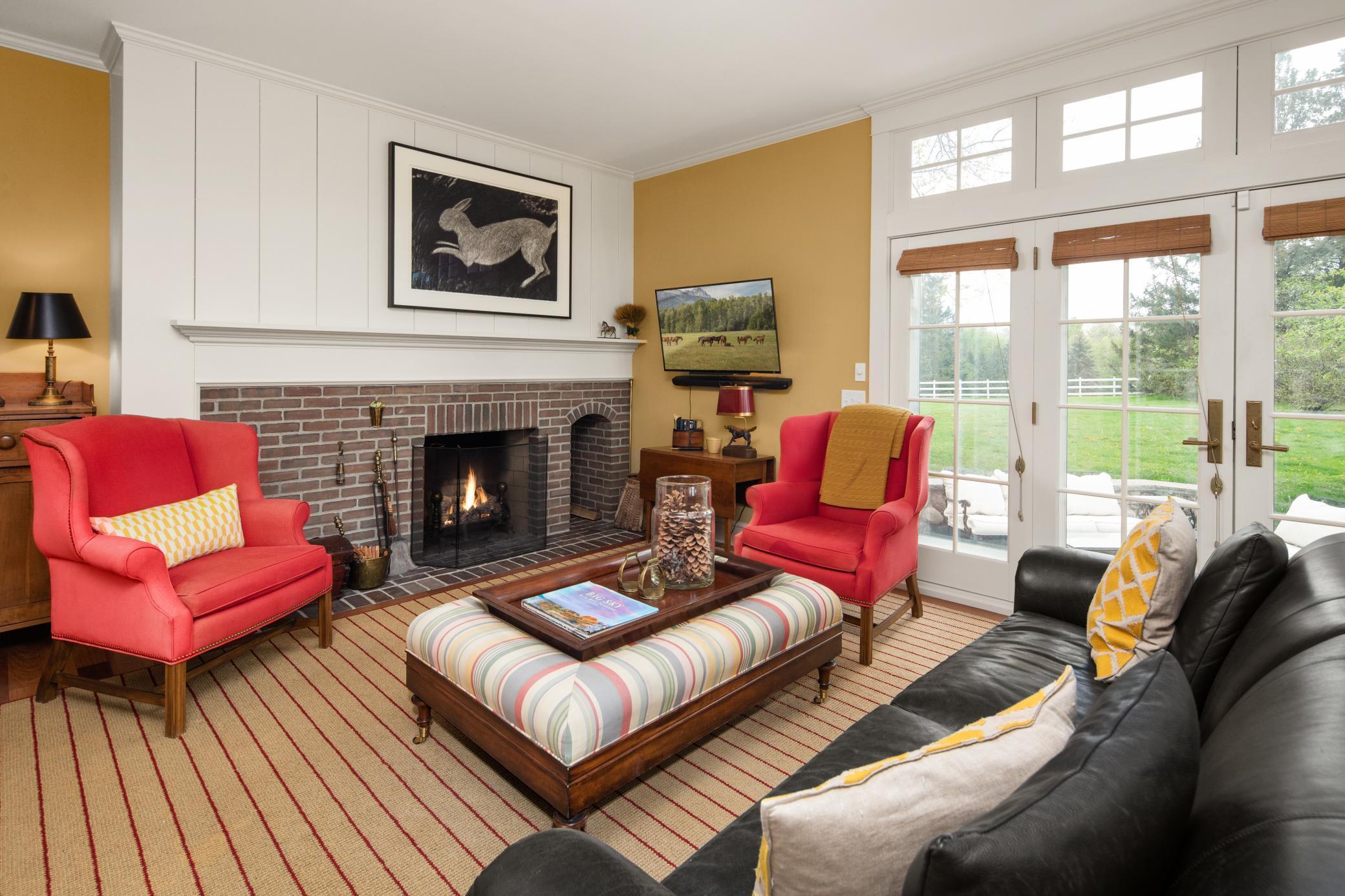 Main level family room with wood burning fireplace leads you to one of many terraces.