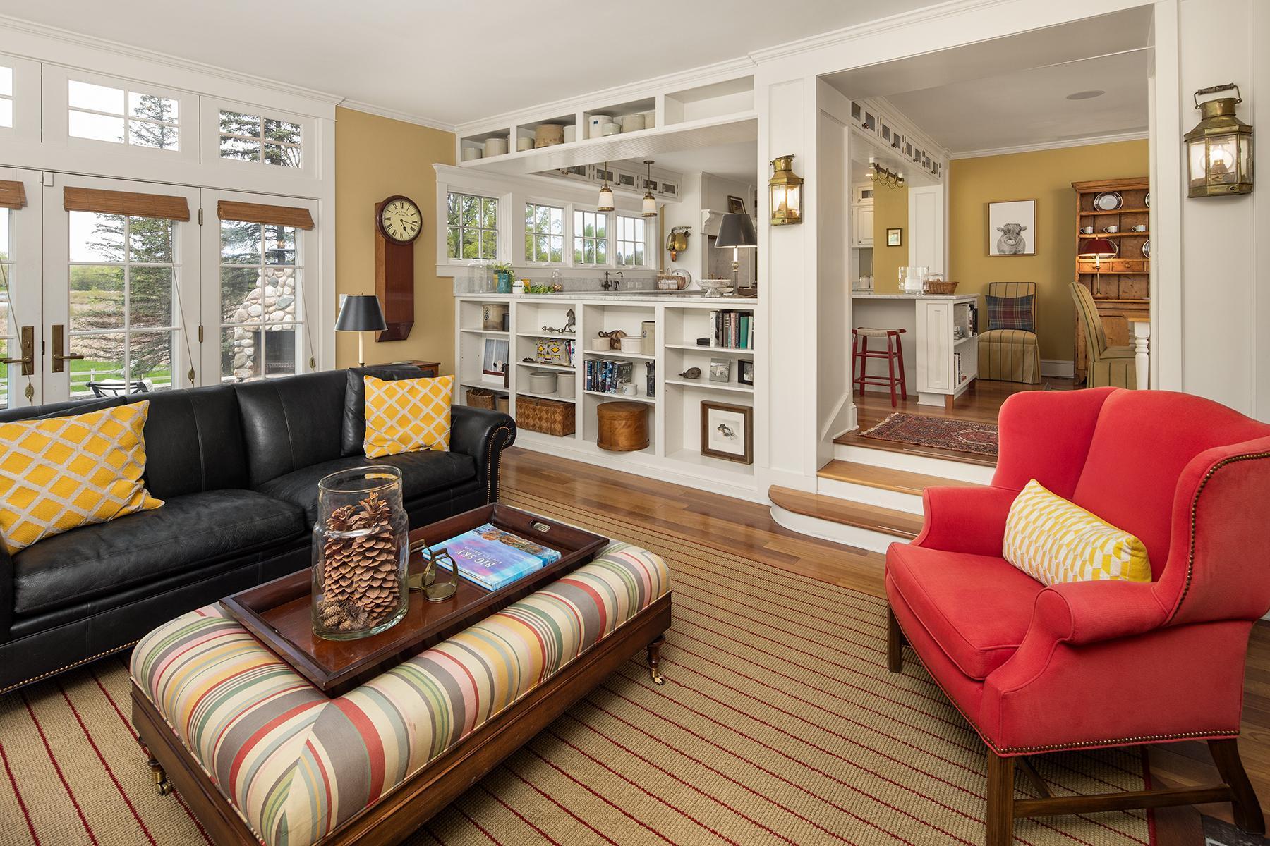 Custom built ins, walls of windows and hardwood floors throughout the main level family room.