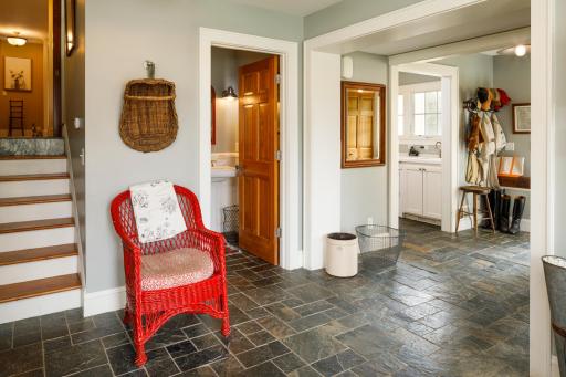 Charming and functional mudroom has direct access to primary residence, 4 stall garage, laundry room (one of two in the primary residence) power room, and courtyard.