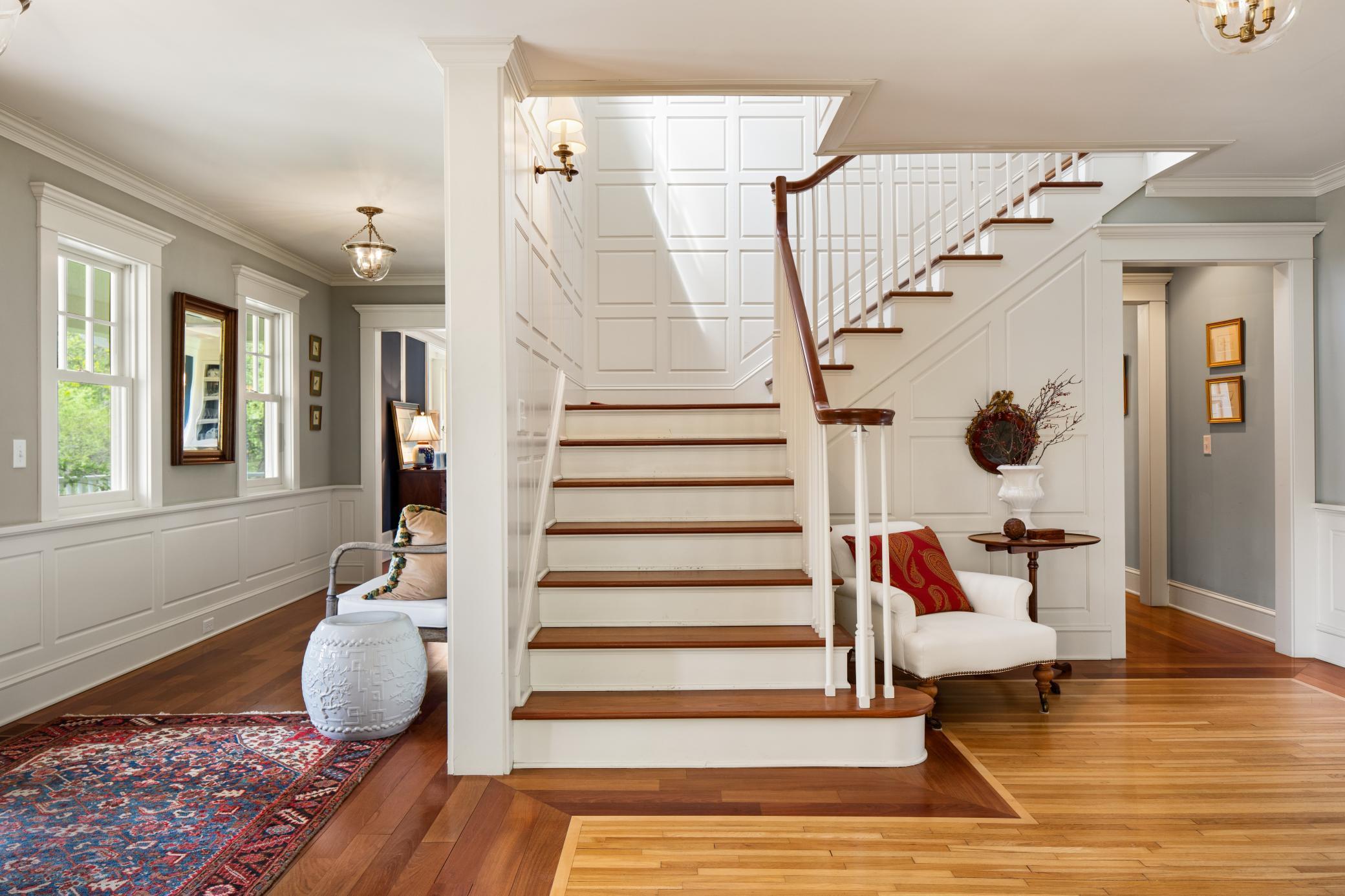 The grand front staircase leads you to the primary residence bedrooms.