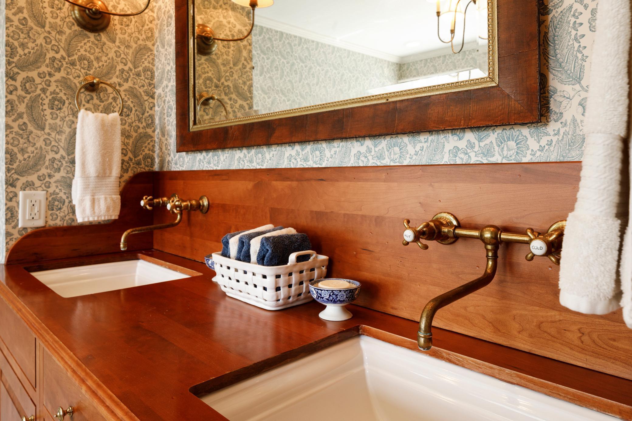 Stunning double vanity in owner's suite with Waterworks fixtures.