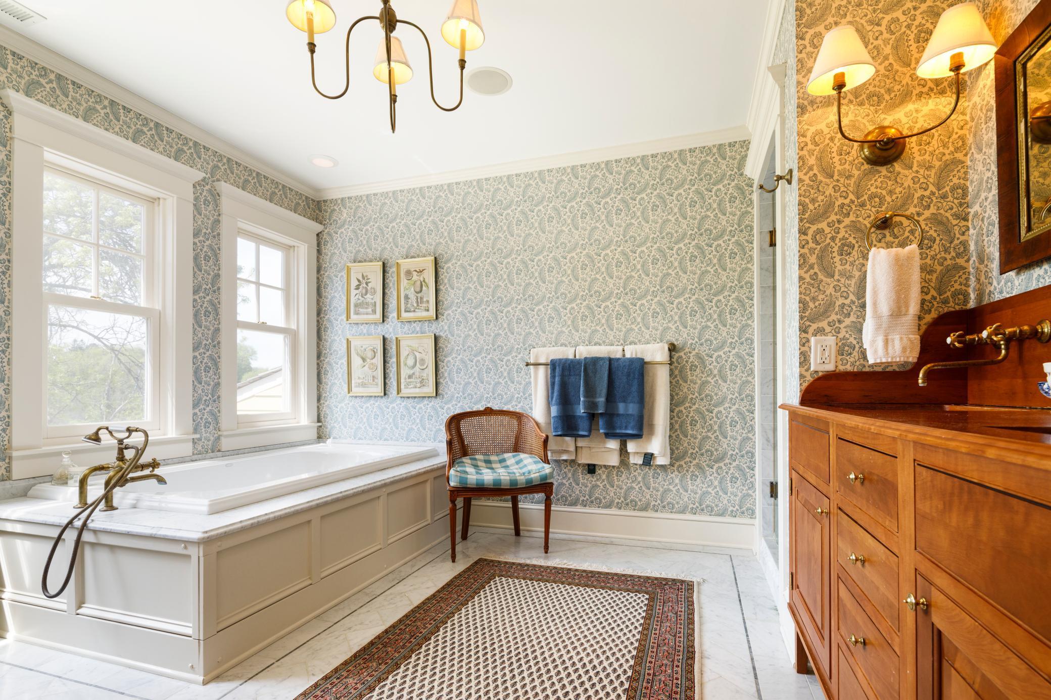The owner's suite full bathroom is filled with natural light and charming details. Separate tub and shower.