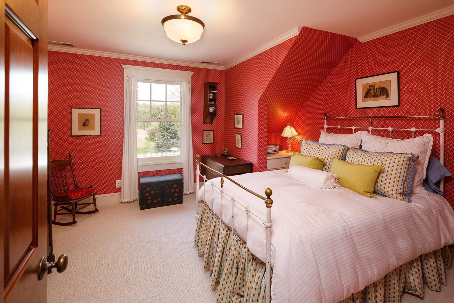 One of two additional bedrooms on the upper level with courtyard views.