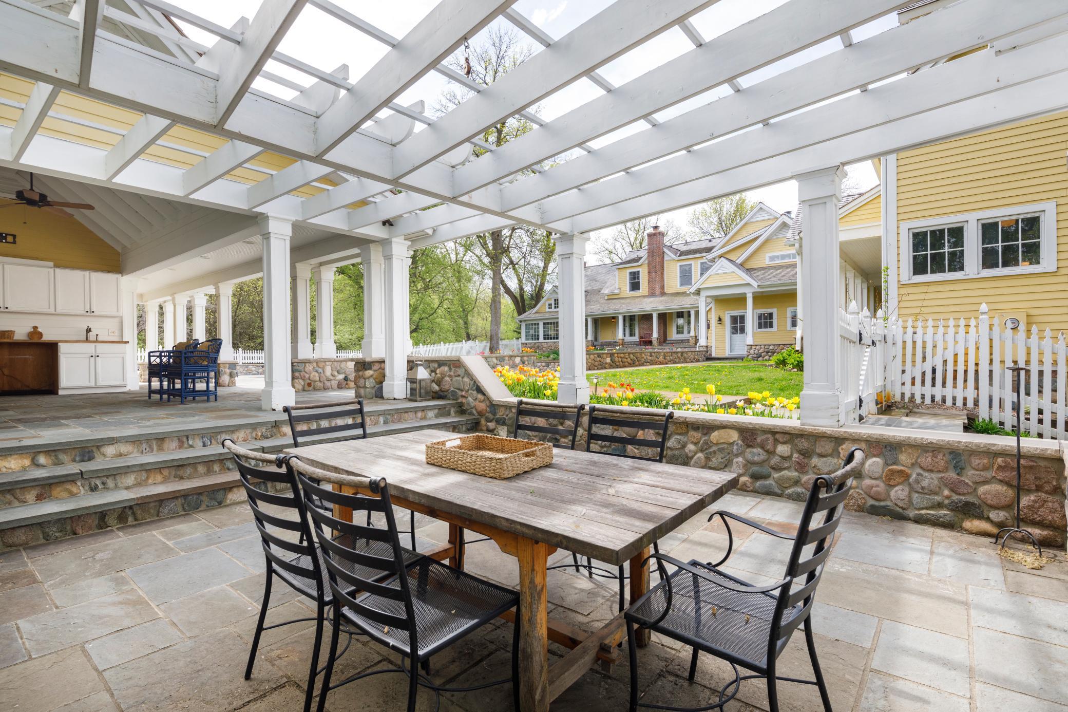 Cabana off of the pool house is surrounded by field stone and blue stone.