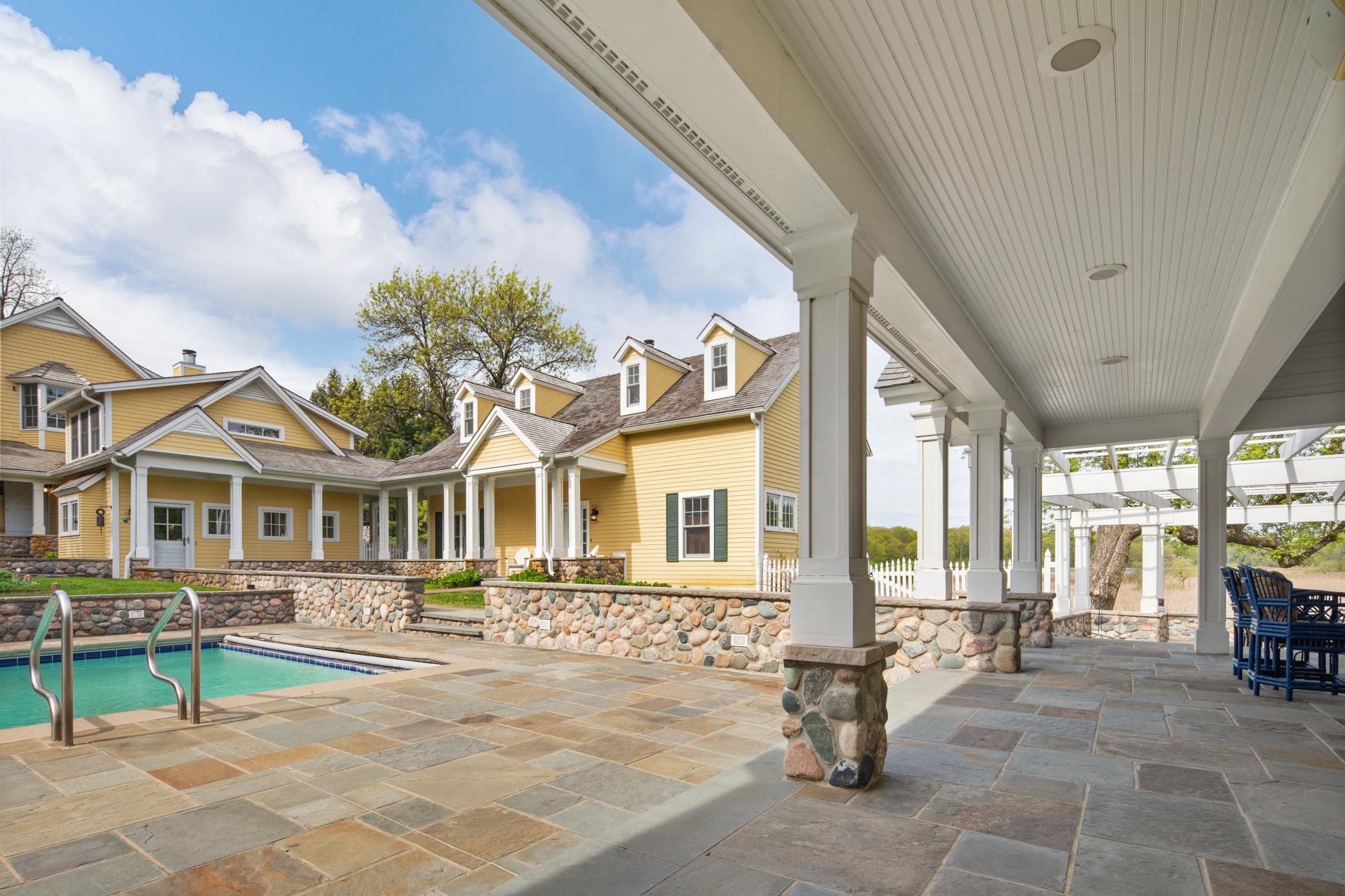 Outdoor gathering spaces surround this spacious home including an outdoor fireplace with built-in gas grill.