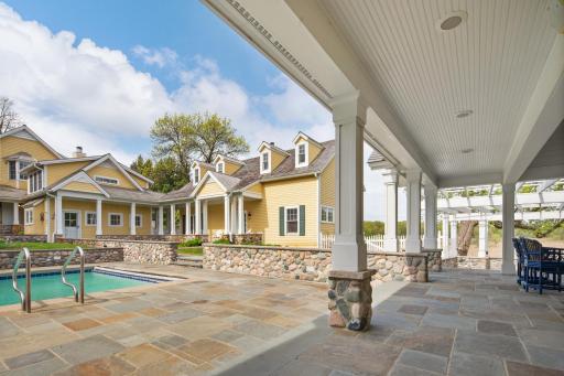 Outdoor gathering spaces surround this spacious home including an outdoor fireplace with built-in gas grill.
