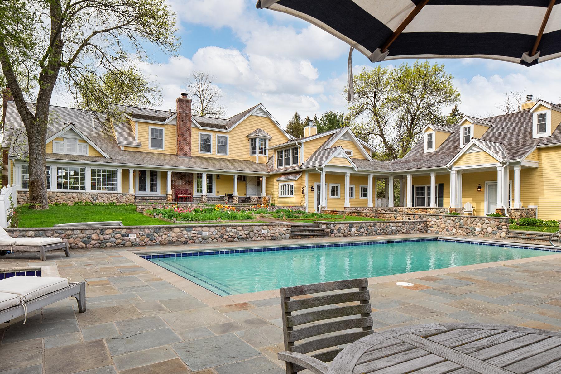 Picturesque English courtyard with gardens and pool.