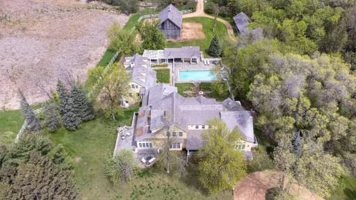 "Creekside Farm" - reimagined, 10-acre, New England inspired estate with primary residence, guest house, pool house, barn, and four garage stalls.