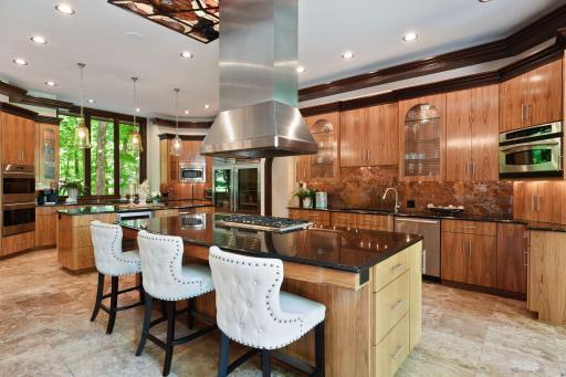 This kitchen island houses a Viking gas cooktop with 6 burners and exhaust hood