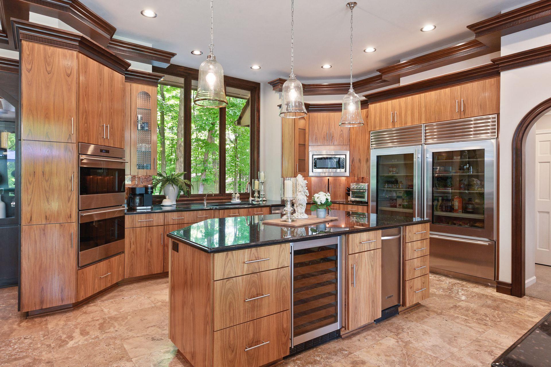 Double Subzero fridges, trash compactor, and wine fridge plus double wall ovens.